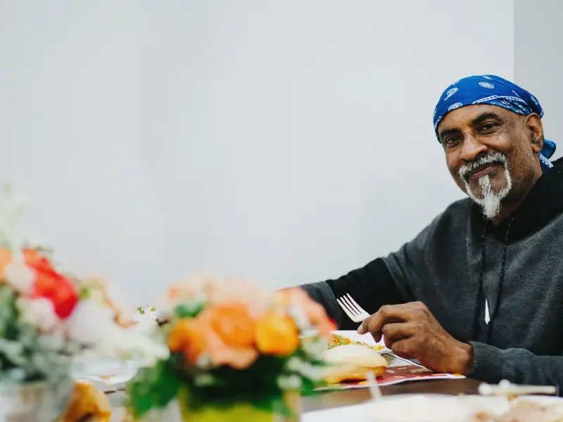 Community Member enjoying a Thanksgiving Meal at UGM