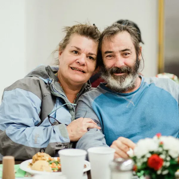 A man and woman enjoying a holiday meal together at UGM.