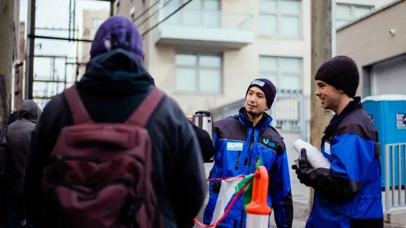 UGM volunteers serving hot chocolate outside